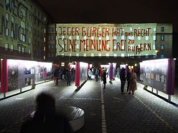 Blick auf "Haus 7" mit Projektion des Protestslogans "Jeder Bürger hat das Recht seine Meinung frei zu äußern"