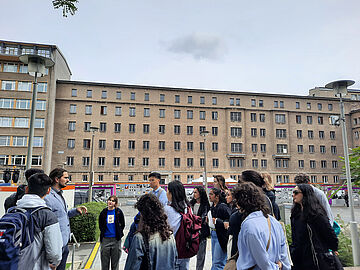 Studierende aus Kanada stehen im Innenhof der ehemaligen Stasi-Zentrale. Im Hintergrund ist Haus 1 zu sehen.